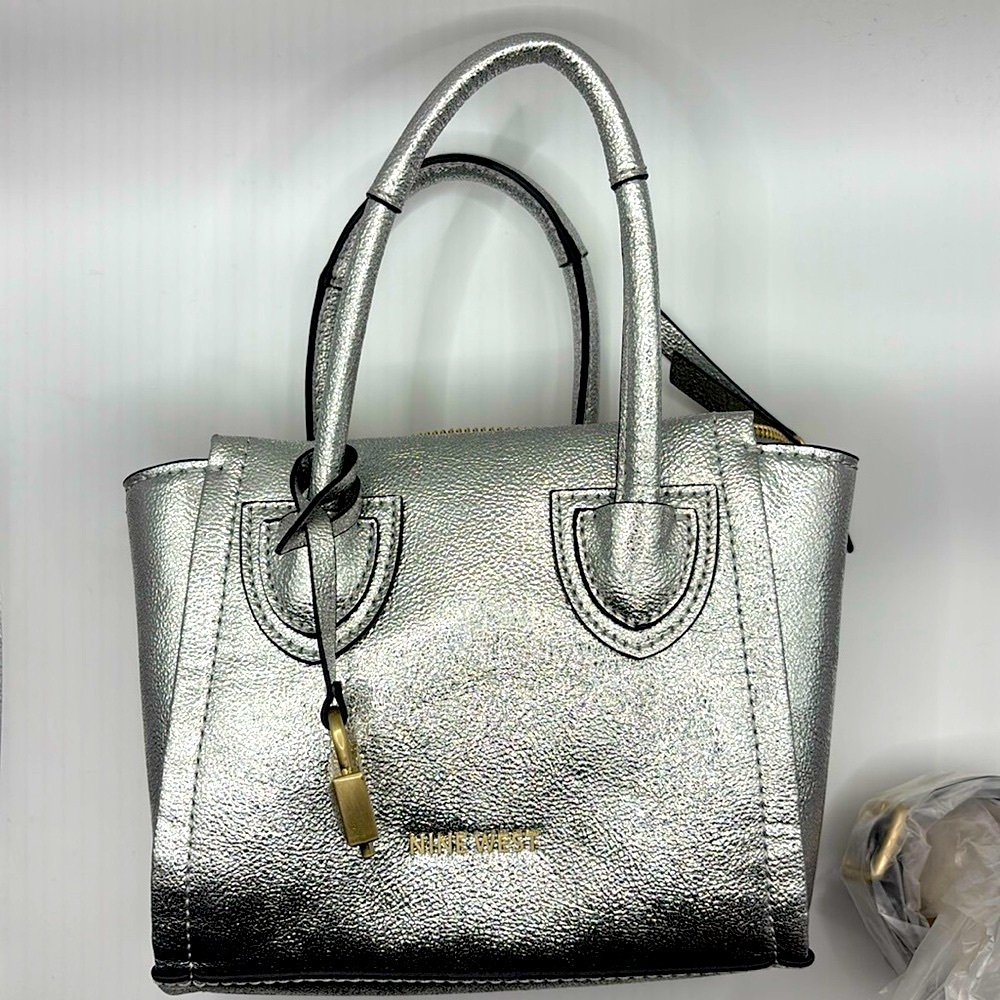 Nine West metallic color small crossbody purse with decorative lock.